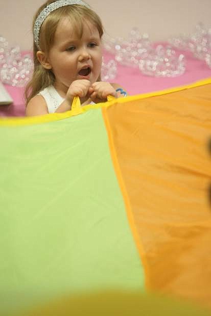 Four-year-old Emma Garber plays with a parachute during princess training on Saturday at the Children&#039;s Museum of Northern Nevada.