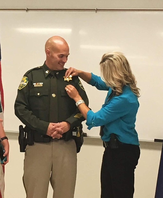 Captain Brian Humphrey is pinned by his fiancee Ali Banister after being promoted from lieutenant to captain Thursday afternoon.