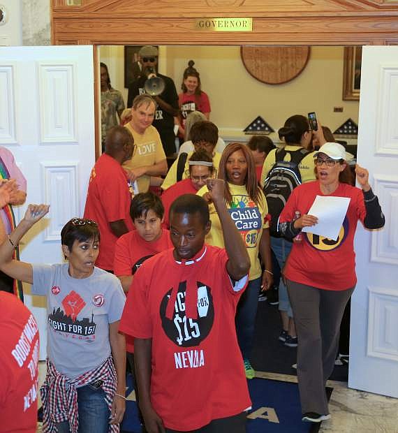 Protesters leave Gov. Brian Sandoval&#039;s office on Monday after reading and delivering a Moral Declaration calling on elected officials and candidates for office to embrace morally just policies like a $15/hour wage and health care for all, and to stand against racism, sexism, discrimination and attacks on voting rights.