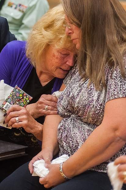 Peggy Eddington-Smith, 69, of Dayton, Nev., and Donna Gregory of St. Louis hug during a ceremony in Dayton, Nev., on Saturday, Sept. 21, 2013. Eddington-Smith&#039;s father, Pfc. John Eddington, died in World War II three weeks after her birth. A box of Eddington&#039;s personal items were discovered by Donna Gregory of St. Louis who traveled across the country to hand deliver the items to Eddington-Smith. (AP Photo/Kevin Clifford)