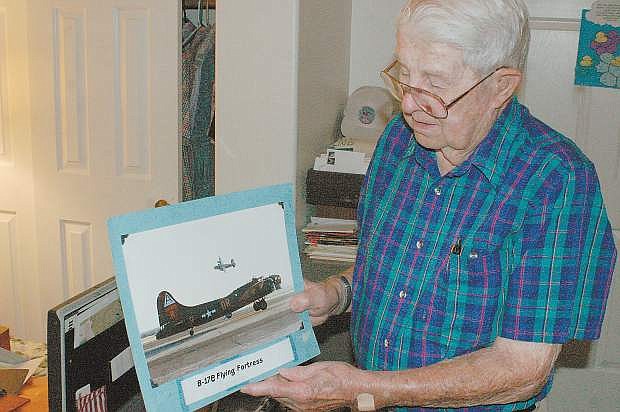 In this 2007 photo Cecil Quinley points to a B-17 similar to the one he flew during World War II.