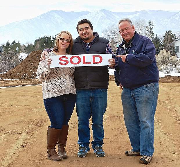 Scott Smith of Re/Max Realty Affiliates in Gardnerville congratulates future homeowners Gary Dolan and Ashley Overlock after the first Canyon Vista home sold. Canyon Vista is on the corner of Clearview and Hillview drives in Carson City.