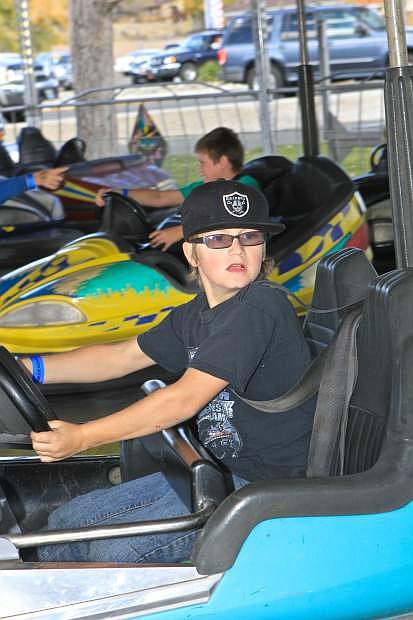 9-year-old Gabe Brackin looks for someone to run into on the bumper car ride at Mills Park Friday.