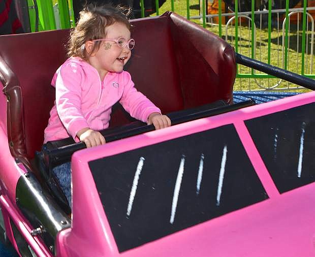 Two-year-old Zoey Damron of Gardnerville enjoys her first carnval ride at the RSVP fair Friday at Mills Park. The fair and carnival continue from 1-5 p.m. today and Sunday. For more information visit: http://www.nevadaruralrsvp.org