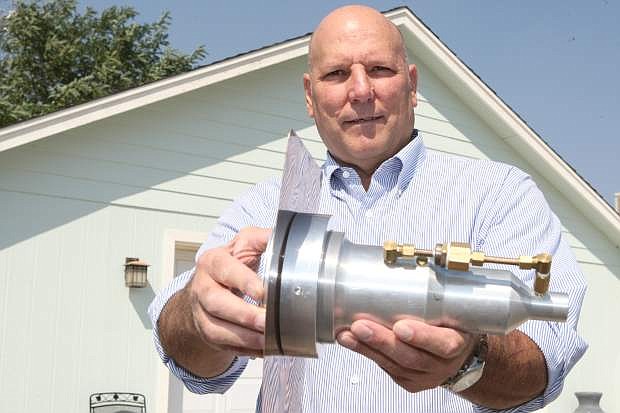 Floyd Heaton shows the roof-mounted sprinkler for the Rain Makers Inc. system at home in Washoe Valley.