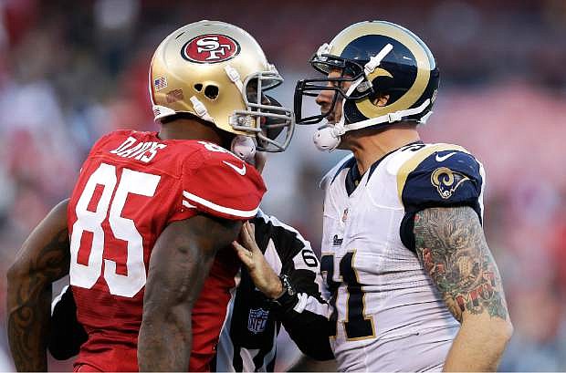 San Francisco 49ers tight end Vernon Davis (85) faces off with St. Louis Rams defensive end Chris Long during the fourth quarter of an NFL football game in San Francisco, Sunday, Dec. 1, 2013. (AP Photo/Marcio Jose Sanchez)
