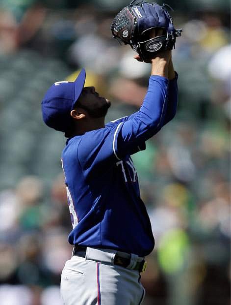 Texas Rangers&#039; Martin Perez celebrates at the end of a baseball game against the Oakland Athletics, Wednesday, April 23, 2014, in Oakland, Calif. Perez pitched his second consecutive shutout to extend his scoreless innings streak to 26, giving Texas a 3-0 win. (AP Photo/Ben Margot)