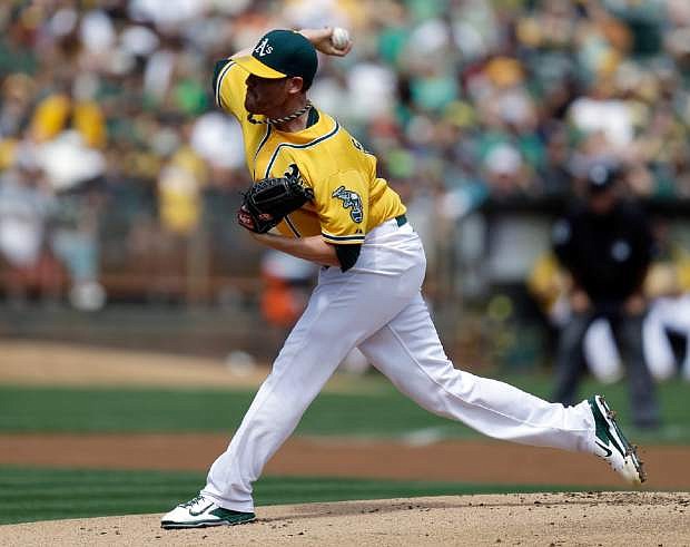 Oakland Athletics&#039; Dan Straily works against the Texas Rangers in the first inning of a baseball game, Monday, Sept. 2, 2013, in Oakland, Calif. (AP Photo/Ben Margot)