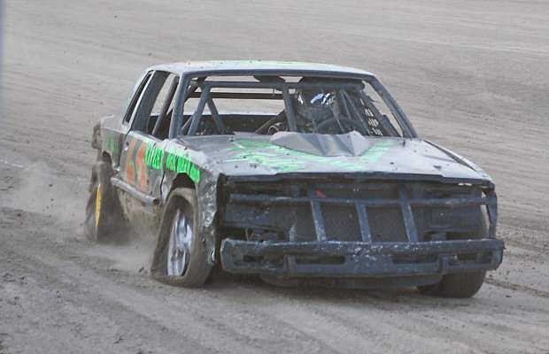 David Ausano rolls off the track with two tires off kilter winning Sunday&#039;s first heat of the Hobby Stock races at Rattlesnake Raceway.