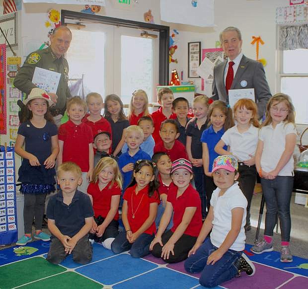 Michele Cacioppo&#039;s kindergarten class stands with Carson City Mayor Bob Crowell and Sheriff Ken Furlong at Bordewich-Bray Elementary after the students presented the men with their homemade book they dedicated to public servants..