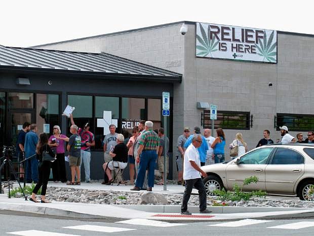Dozens of people lined up outside the Silver State Relief medical marijuana dispensary in Sparks, Nevada last year. A ballot question on legalization is now meeting with opposition from big names in Nevada politics.