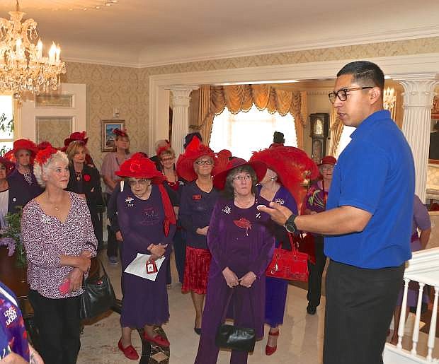 Governor&#039;s Mansion employee Cesar Rocha gives Red Hat Society members a tour of the historical building Thursday afternoon in Carson City.