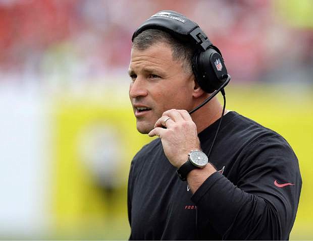 FILE - In a Sunday, Dec. 15, 2013 file photo, Tampa Bay Buccaneers head coach Greg Schiano watches during the first quarter of an NFL football game against the San Francisco 49ers, in Tampa, Fla. The Tampa Bay Buccaneers announced Monday, Dec. 30, 2013 that they have fired coach Greg Schiano and general manager Mark Dominik following a 4-12 finish. (AP Photo/Chris O&#039;Meara, File)