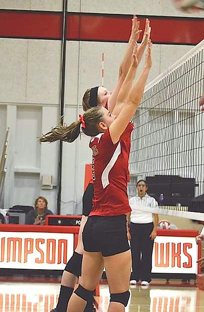 Former Lady Wave volleyball player Kelsey Reibsamen attempts to block a shot during a match for Simpson University this year.
