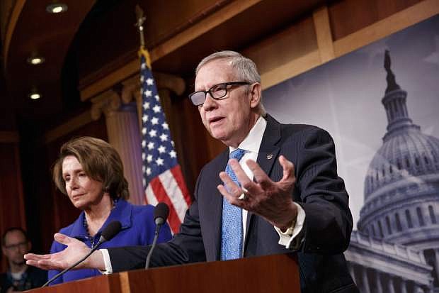 FILE - In this Feb. 26, 2015 file photo, Senate Minority Leader Harry Reid of Nev., accompanied by House Minority Leader Nancy Pelosi of Calif., gestures during a news conference on Capitol Hill in Washington. Reid is announcing he will not seek re-election to another term. The 75-year-old Reid says in a statement issued by his office Friday that he wants to make sure Democrats regain control of the Senate next year and that it would be &quot;inappropriate&quot; for him to soak up campaign resources when he could be focusing on putting the Democrats back in power.  (AP Photo/J. Scott Applewhite)