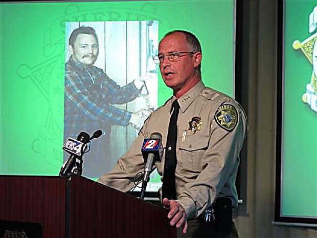 Storey County Sheriff Gerald Antinoro speaks to reporters at Washoe County sheriff&#039;s headquarters in Reno, Nev., Thursday, May 1, 2014, about the opening of an investigation into the apparent 1980 homicide of George Benson Webster of Sun Valley, who is pictured in the background. The highly decorated Vietnam veteran had been missing since then. His remains were found last summer in a septic tank at a home on the edge of the historic Comstock mining town of Virginia City about 20 miles from Reno. Detectives traced his identity with the help of a partial serial number on a medallion with the remains. (AP Photo/Scott Sonner)