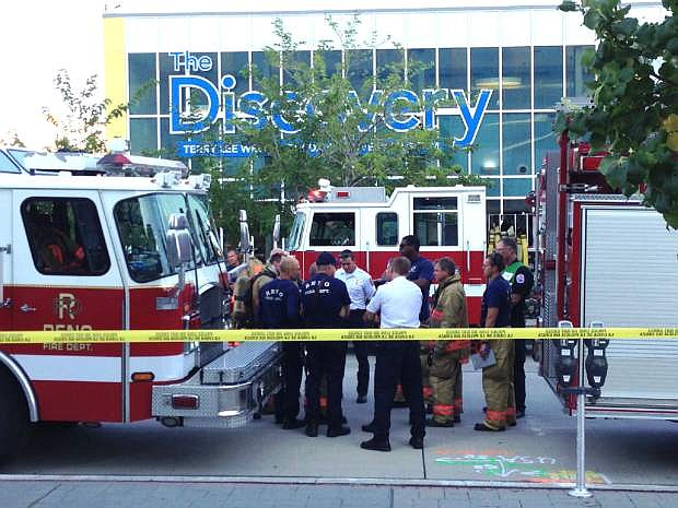 Firefighters confer out side the Nevada Disvory Museum in Reno, Nev., Wednesday Sept. 3, 2014. A minor explosion during a science experiment at the museum burned several children and forced the evacuation of the museum..   (AP Photo/Scott Sonner).