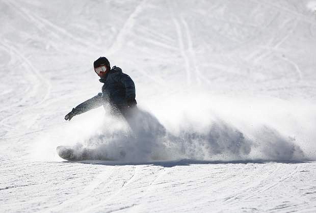 A snowboarder on Friday rides down to Stagecoach Express, a chairlift at Heavenly Mountain Resort that opened Wednesday.
