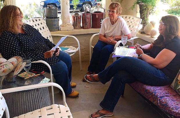 Sue McCormick,left, Bunny Corkill and Tammy Grace,right, discuss the schedule for the Community Wide Reunion at McCormick&#039;s home.