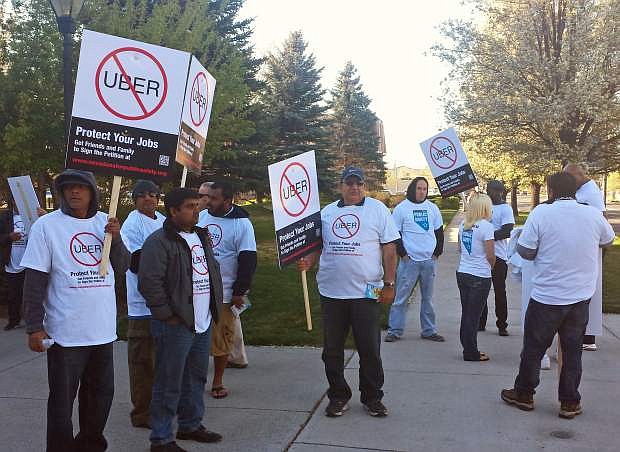 Demonstrators protest against ride-hailing company Uber in Carson City, Nev., on Monday, March 30, 2015. Nevada lawmakers are considering bills that would create regulations specific to companies like Uber and Lyft, but cab companies decry them as &quot;special treatment.&quot; (AP Photo/Michelle Rindels)