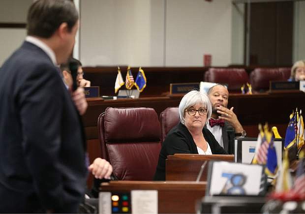 Nevada Senate Democrats Debbie Smith and Aaron Ford listen to Majority Leader Michael Roberson, R-Henderson, during Senate floor debate at the Legislative Building in Carson City, Nev., on Friday, May 8, 2015. Lawmakers voted down a bill allowing for ride-hailing companies like Uber and Lyft in a 13-7 vote that was one vote short of the two-thirds majority needed to pass. (AP Photo/Cathleen Allison)