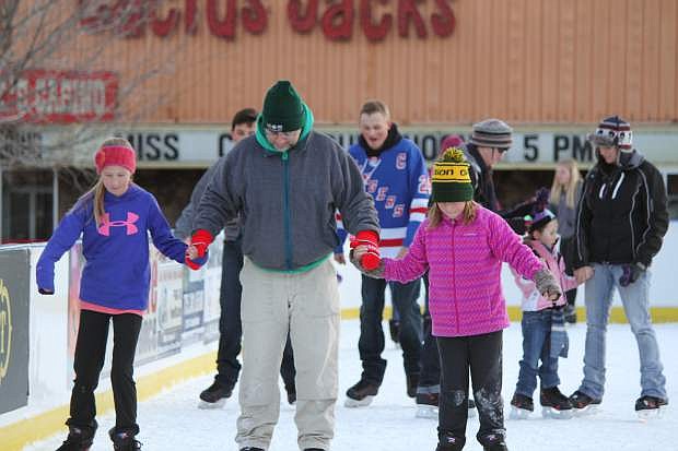 A group of skaters enjoy opening day for the Arlington Square ice rink Friday in Carson City.