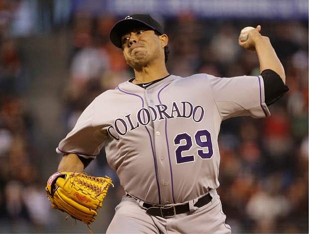 Colorado Rockies starting pitcher Jorge De La Rosa throws against the San Francisco Giants in the first inning of a baseball game Friday, April 11, 2014, in San Francisco. (AP Photo/Eric Risberg)