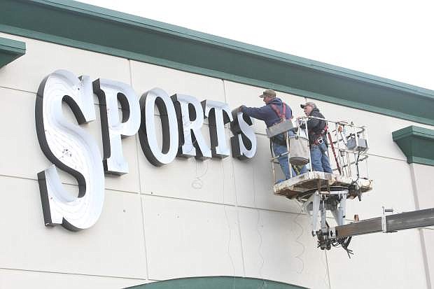 The sign for Sportsman&#039;s Warehouse in the Carson Mall being installed on Wednesday.