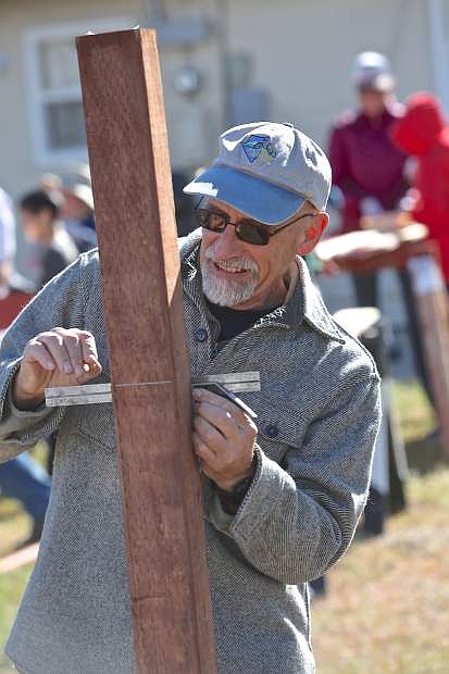 Chas Macquarie of the Carson City Rotary measures fence posts Saturday at the Stewart Indian Colony. Both Rotary clubs (Carson City and Carson Sunset) undertook a service project for FISH (Friends In Service Helping) by replacing and repairing fences at their transitional housing sites.