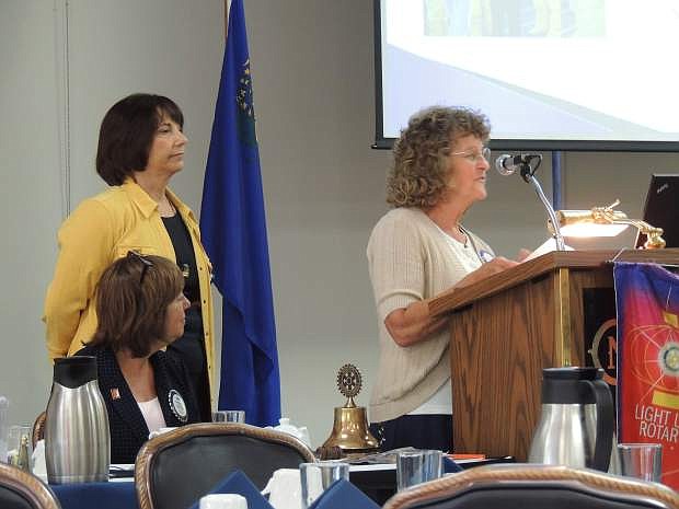 Karen Allen speaks while Angela Barosso (standing) and Anne Hansen, Rotary president, listen Tuesday.