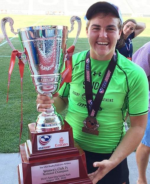 Sara Parsons, in her first year with the Scion Sirens, holds the Club Seven National Championship trophy for womens rugby after her team won the title on Sunday.