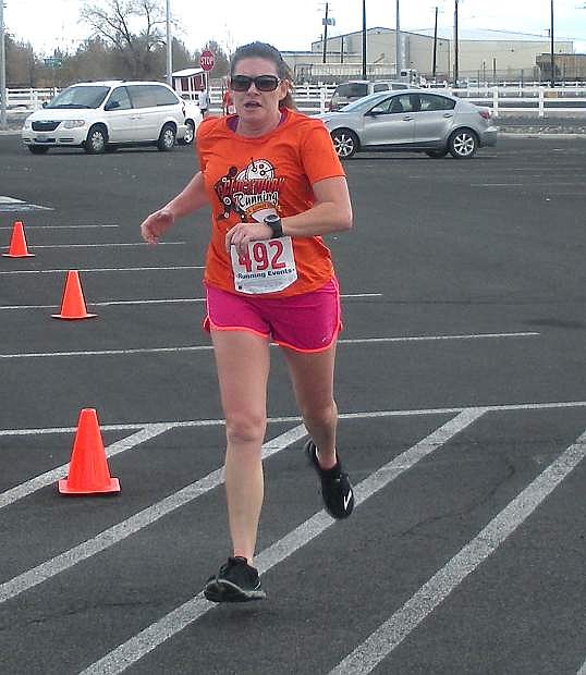 Marianne Woller crosses the finish line to win the women&#039;s overall run during Saturday&#039;s annual Turkey Trot 5K Run/Walk at the Fallon Convention Center.