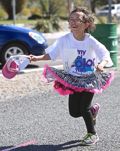 2nd grader Feather Moreia runs the Mark Twain Color Run Saturday at Mills Park.