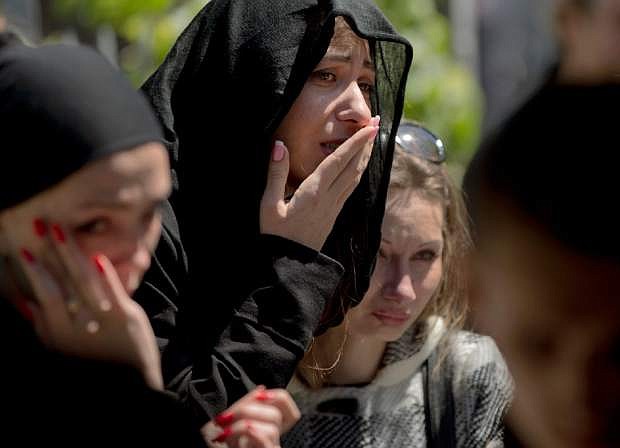 The girlfriend, center, of Andrei Brazhevskiy, a pro-Russian activist, cries during his funeral in Odessa, Ukraine, Wednesday, May 7, 2014. Brazhevskiy, 27, died after jumping out of the burning trade union building in an attempt to escape Friday&#039;s fire that killed most of the 40 people that died after riots erupted last Friday. Girlfriend&#039;s name is not available. (AP Photo/Vadim Ghirda)