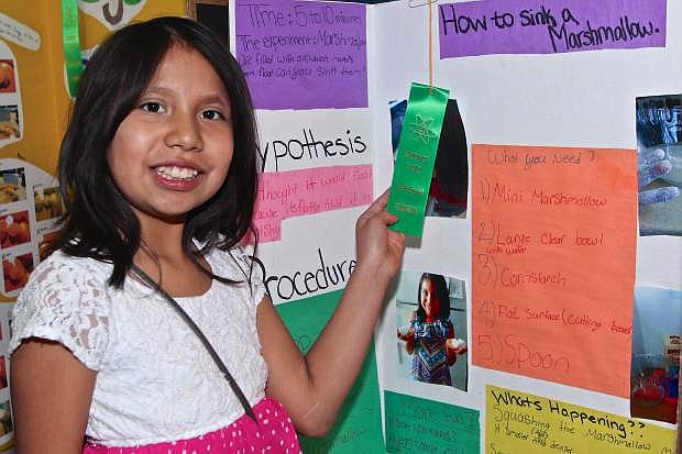 9-year-old Sequoia Skenandore shows her project  &#039;How to Sink a Marshmallow&#039; at Empire Elementary&#039;s STEM Night Thursday.