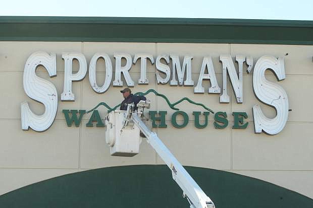 Jeff Howser of YESCO installs neon tubing to the exterior Sportsman&#039;s Warehouse signage on Monday afternoon.