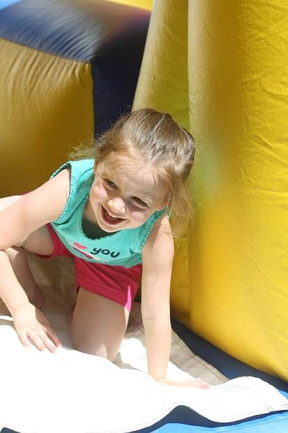 Lanie Kipling crawls out of an inflatable toy at Mills Park during last year&#039;s Food for Thought Saddle Up for Kids event.