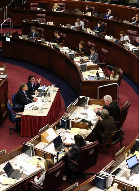 Nevada Gov. Brian Sandoval&#039;s Chief of Staff Mike Willden, center left, and Economist Jeremy Aguero testify in an Assembly Committee of the Whole hearing at the Legislative Building on Saturday.
