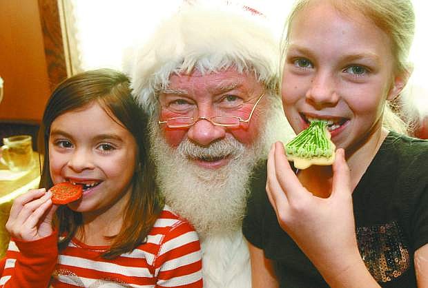 Cheyenne LaBranch, left, and Aleah Chavez meet Santa at Adele&#039;s 3rd annual Cookies with Santa last year. This year&#039;s event will take place on Dec. 21.