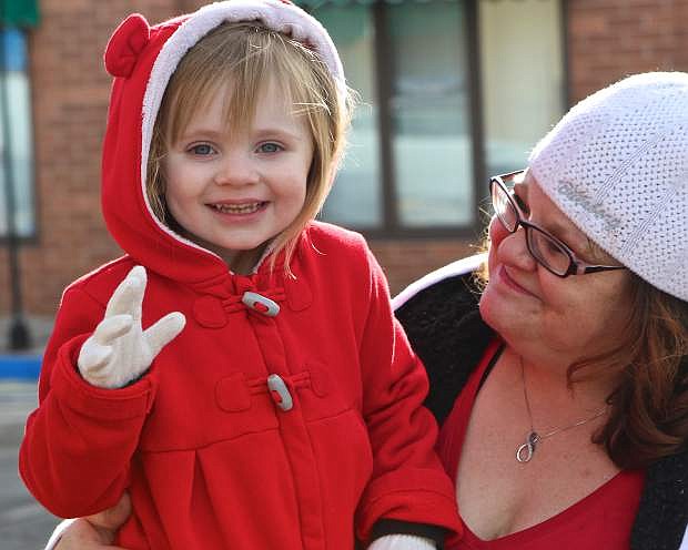 3-year-old Hope Gasper and her mother Michelle enjoy the Old Time Santa parade Saturday.