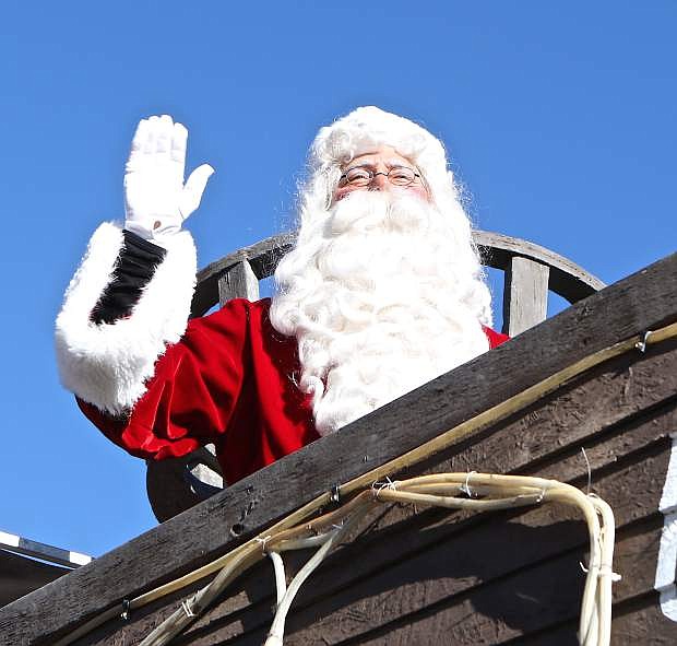 Santa Claus waves from the upper deck of the &#039;USS Nevada&#039; during last year&#039;s Olde Time Christmas Santa Parade.