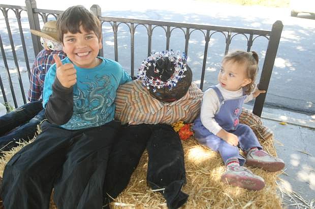 Six-year-old Erik and 23-month-old Tegan Hill with the scarecrow they made at the Children&#039;s Museum of Northern Nevada on Saturday.