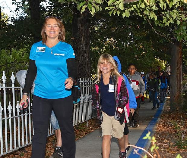Bordewich-Bray Elementary teacher Nancy Varner leads the charge southward on Mountain St. with 2nd grader Brooklyn Berg during International Walk-To-School Day Wednesday morning in Carson City.