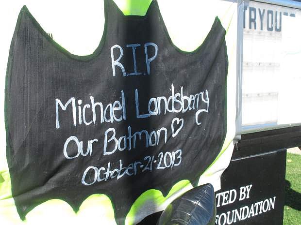 Michael Landsberry&#039;s reputation as a big fan of Batman figures prominently in the makeshift memorial in front of Sparks Middle School Wednesday, Oct. 23, 2013, in Sparks, Nev.   Landsberry  was killed and two students wounded at teh school before a 12-year-old gunman turned a handgun on himself on Oct. 21, 2013. (AP Photo/Scott Sonner).