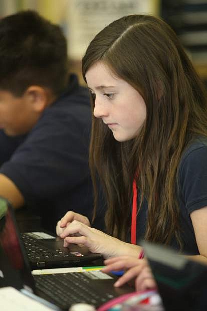 Carson Middle School sixth-grader Kelly McCready, 11, works on a laptop computer in Vicki Crickon&#039;s social studies class in December.