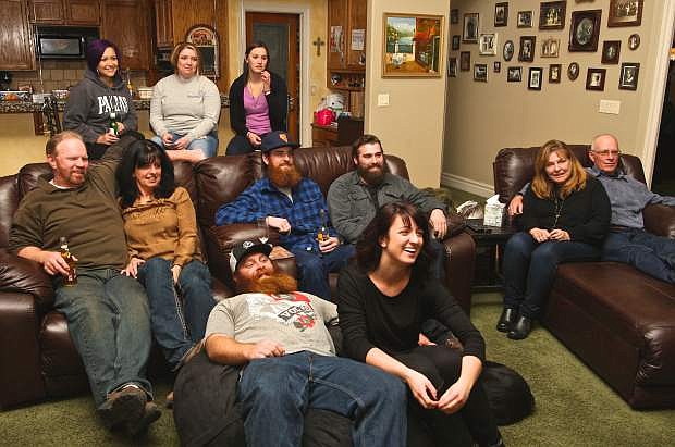 American Idol contestant Molly Seals, center, in black, is surrounded by friends and family during a viewing party at the Seals&#039; house Wednesday night. Back row: The &#039;Band-Aids,&#039; Kelli Luderbaugh, Jenilla McDaniel, Andrea Hlatky, middle: Jim Seals, Marianne Seals, Jimmy Seals, Chase Annand, Molly Sinnott and Paul Sinnot. Seated next to Molly Seals is her boyfriend Kevin Sinnott. The Kansas City auditions in which Molly appears, barring her getting edited, shows tonight on Fox at 8 p.m. and continues this Wednesday Wednesday. Seals is in the running to be one of the 24 finalists to become the next &#039;American Idol&#039; and the 24 finalists were &#039;introduced&#039; on Wednesday, shown singing in silhouettes.