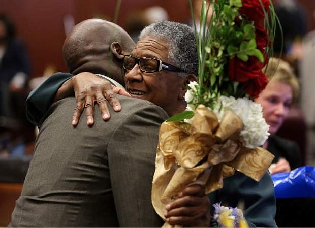 Nevada Sen. Kelvin Atkinson, D-North Las Vegas, left, hugs former Sen. Bernice Mathews following a ceremony inducting her into the Nevada Senate Hall of Fame at the Legislative Building in Carson City, Nev., on Wednesday, April 17, 2013. Sue Wagner, a former senator and lieutenant governor, was also inducted into the Hall of Fame Wednesday. (AP Photo/Cathleen Allison)