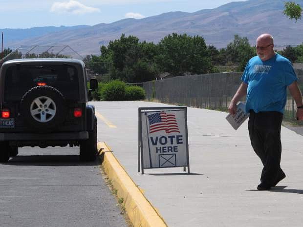 A man leaves the polls at Mendive Middle School in Sparks, Nev., Tuesday, June 14, 2016, after casting his ballot in Nevada&#039;s primary election. Voting was underway Tuesday in Nevada&#039;s primary, which features two fiercely competitive U.S. House contests, a high-stakes U.S. Senate battle and a slate of legislative races. (AP Photo/Scott Sonner)