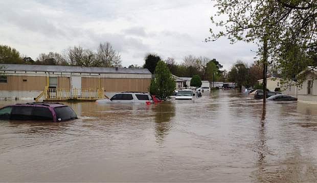 Flood waters cover a street in a mobile home park in Pelham, Ala., on Monday, April 7, 2014. Police and firefighters rescued about a dozen people who were trapped by muddy, fast-moving water after storms dumped torrential rains in central Alabama. (AP Photo/Jay Reeves)