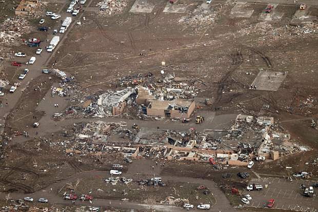 This aerial photo shows damage to Plaza Towers Elementary School after it was hit by a massive tornado in Moore, Okla., Monday May 20, 2013. A tornado roared through the Oklahoma City suburbs Monday, flattening entire neighborhoods, setting buildings on fire and landing a direct blow on an elementary school. (AP Photo/Steve Gooch)